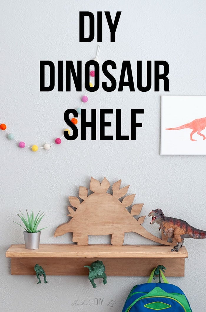 Wooden DIY dinosaur shelf with hooks with backpack and text overlay.