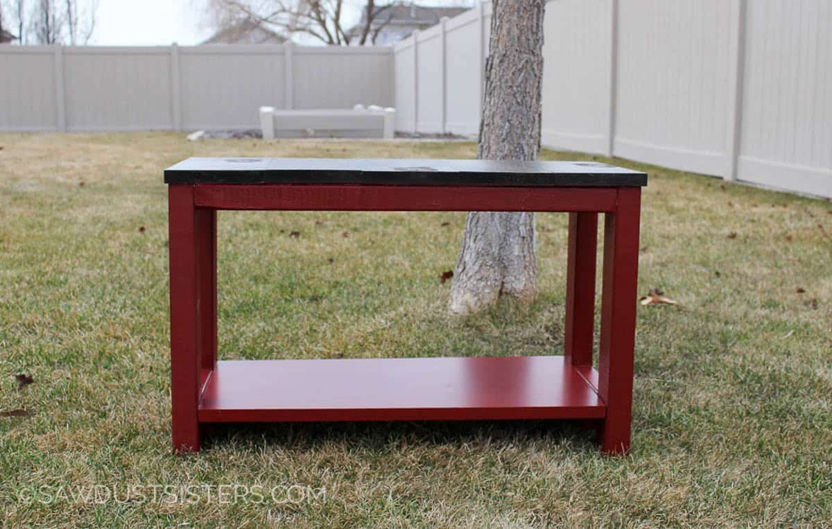 DIY bench with storage shelf sitting outside