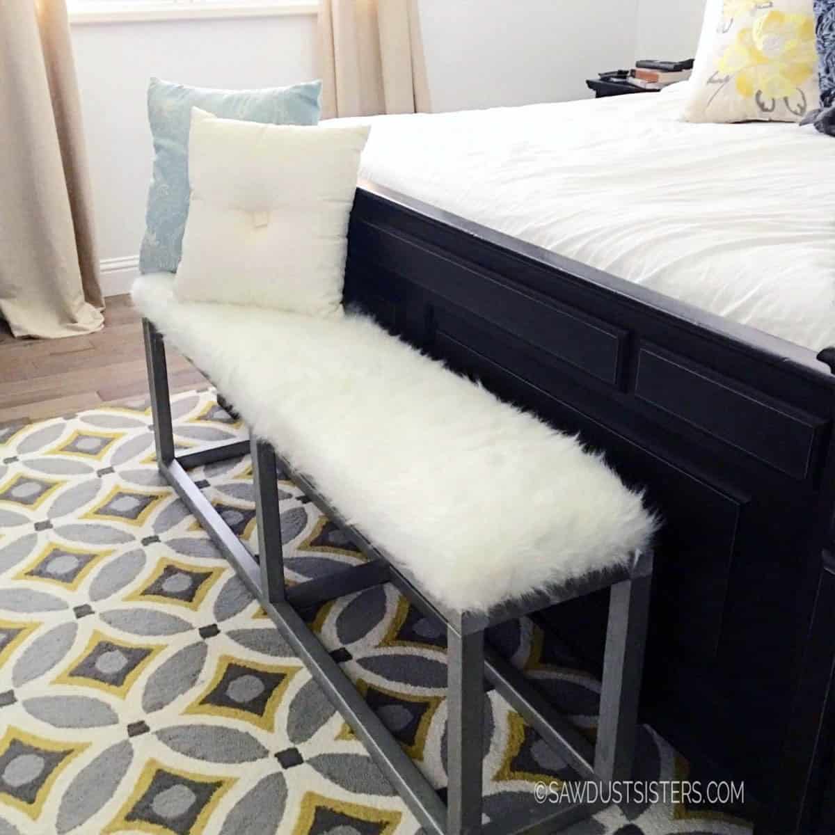 faux metal bench made with wood with white upholstered top