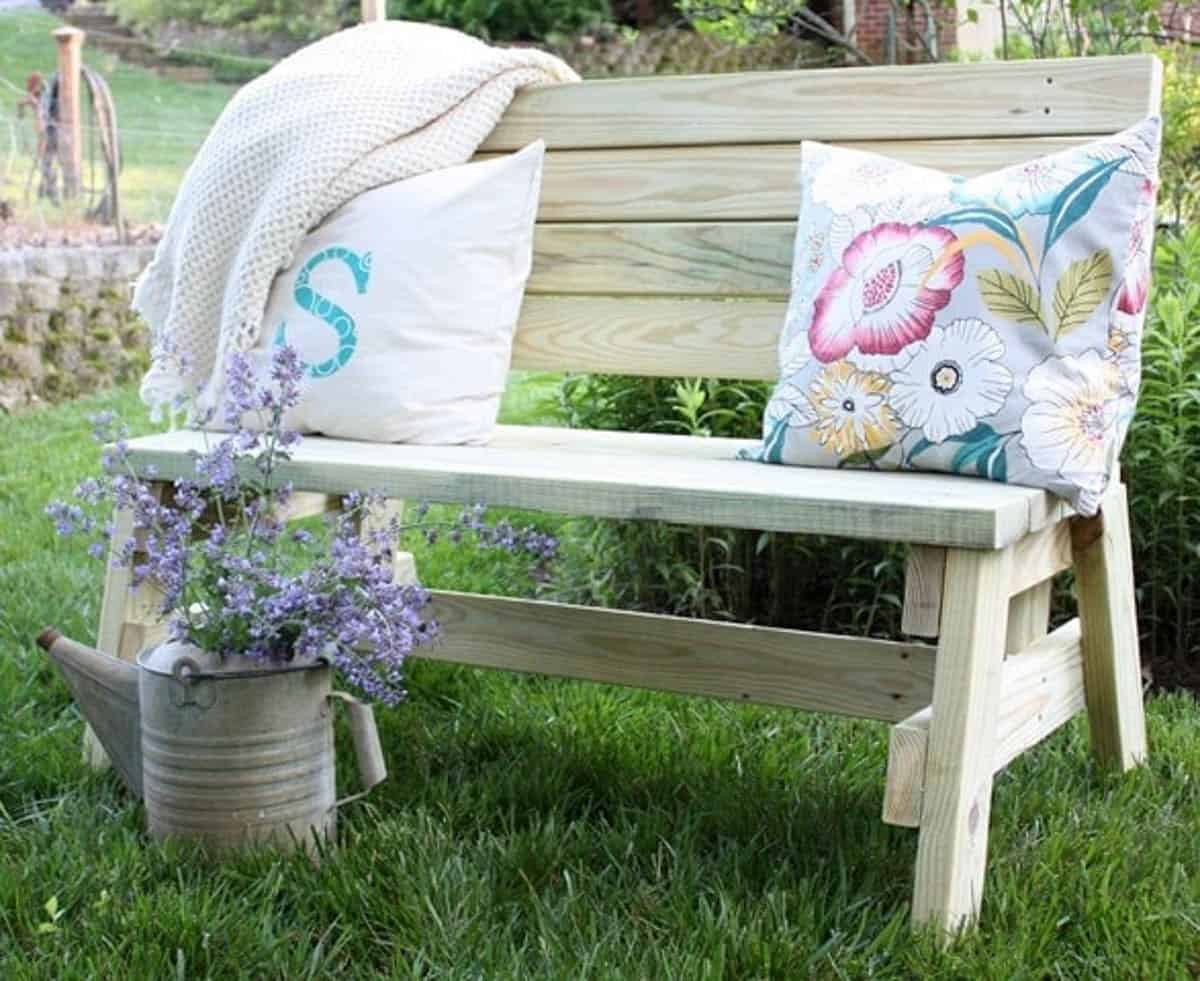 2X4 outdoor bench with pillows and throw