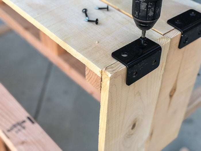 Attaching the cedar planks using corner braces