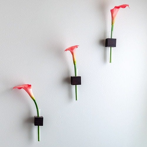 Learn to make this easy DIY test tube bud vase using small pieces of scrap wood. Great quick project that makes gorgeous decor mounted on the wall!