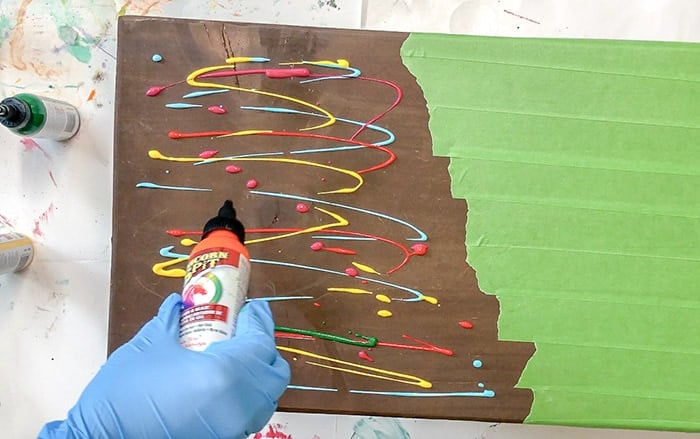 Pouring unicorn spit onto the wooden lap desk top
