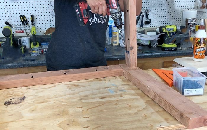 Attaching aprons to the leg frame to build an outdoor dining table