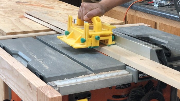 Running the 1x3 boards through the table saw to make a miter edge