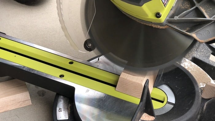 Cutting the beveled ends of the trim for the DIY dining table table top