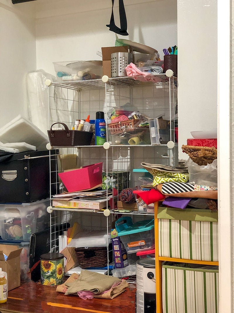 The before of a messy craft clost