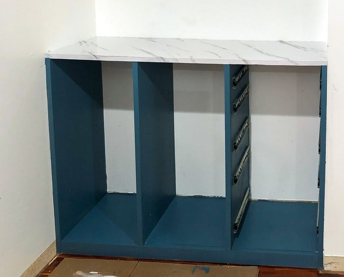 Teal painted Closet organizer with faux marble top