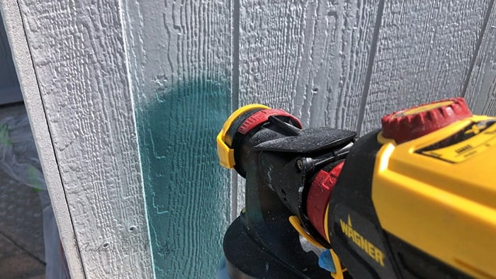 Apraying paint with paint sprayer but there is no overlap with the trim.