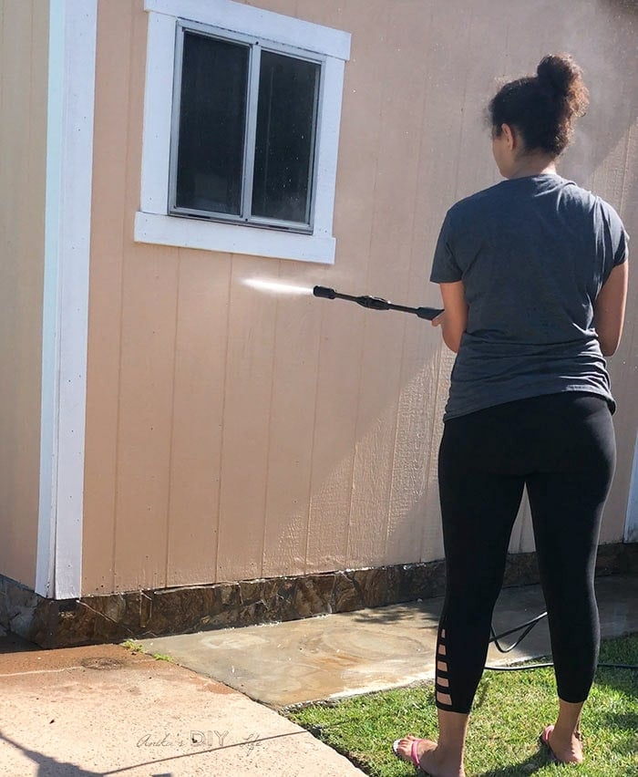 Washing down outdoor garden shed before giving it a makeover