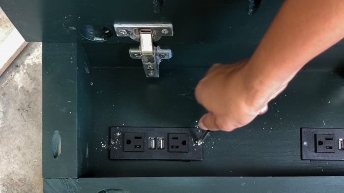 Adding the power strip to create the hidden charging station nightstand