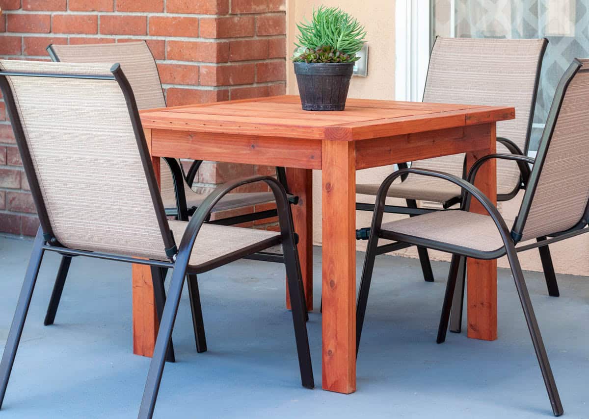 A Simple DIY outdoor dining table on patio with 4 chairs