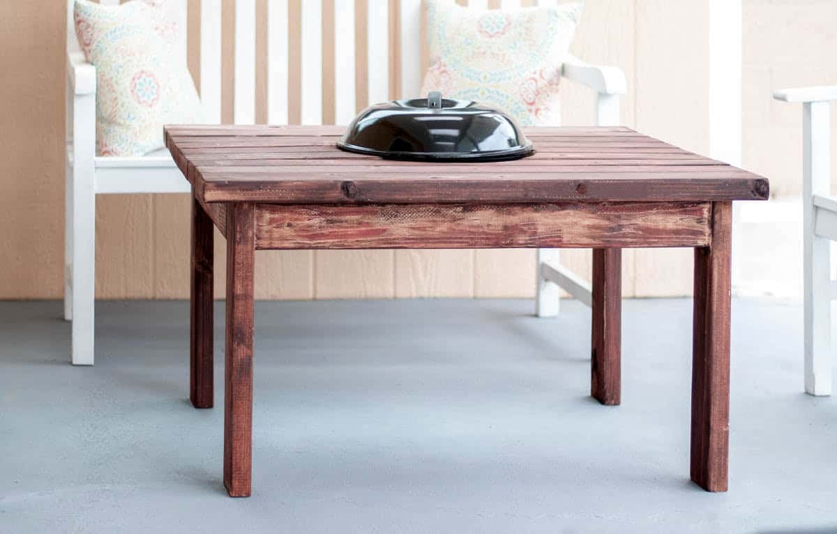A DIY Patio table with fire pit with lid on in the patio
