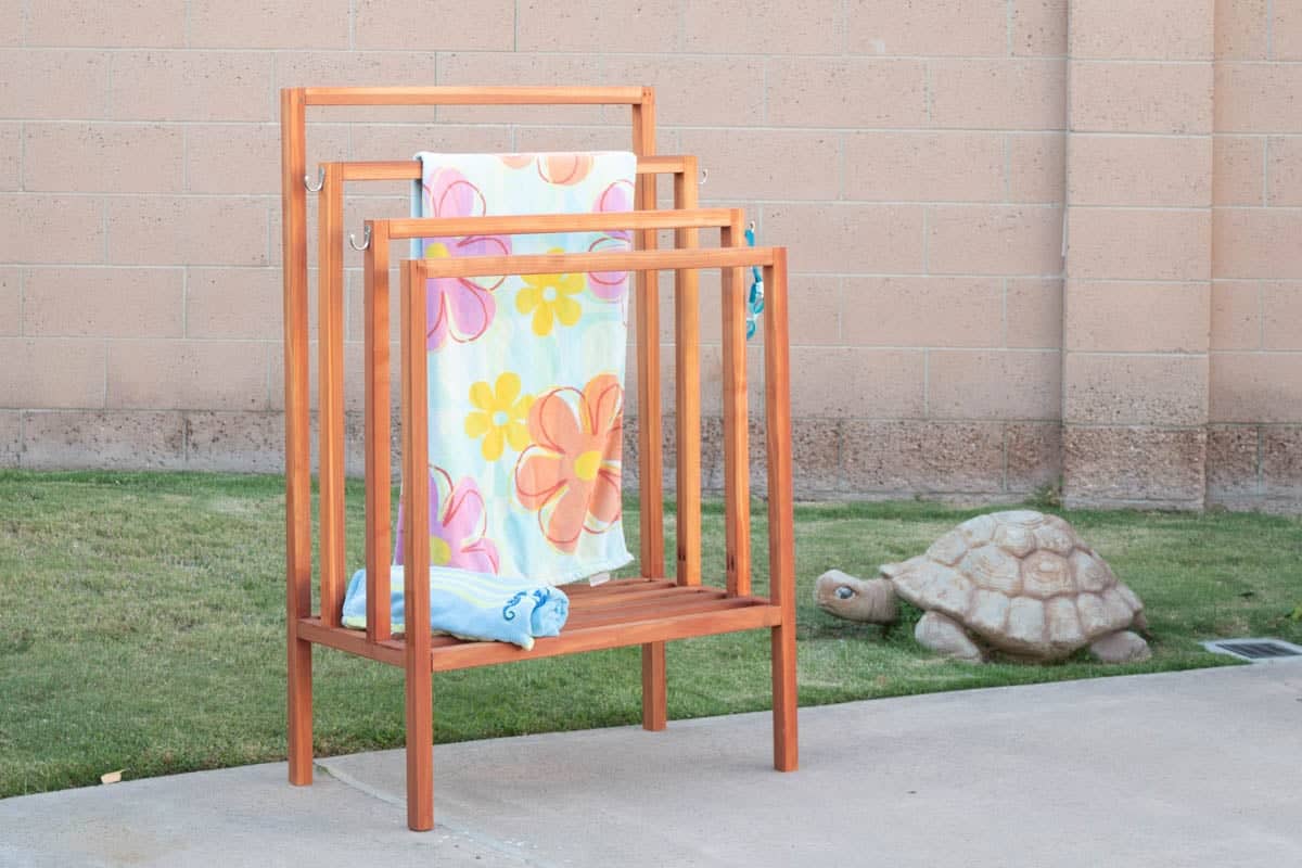 DIY freestanding towel rack in backyard next to pool