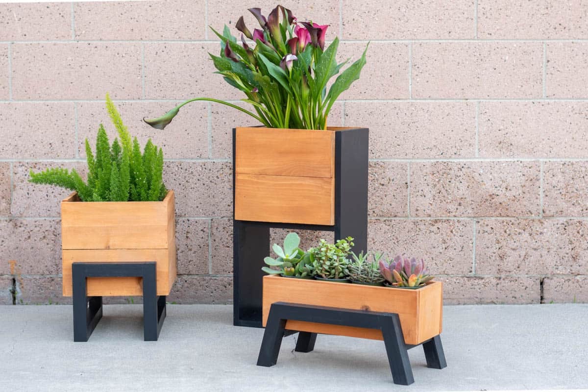 3 modern outdoor planters made with cedar fence boards with black accents