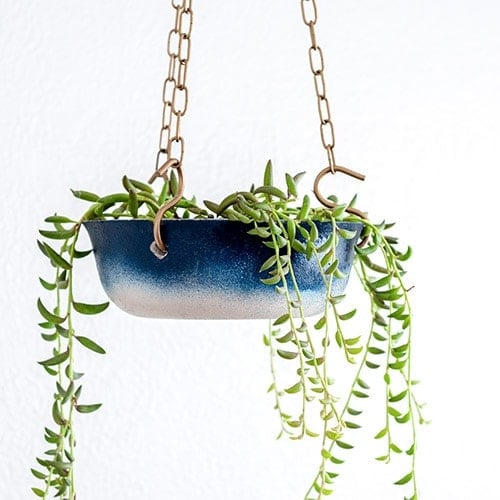 Learn how to make a DIY hanging concrete planter and give it a pretty ombre effect using Rust-Oleum spray paint. It makes the perfect hanging planter for any room.