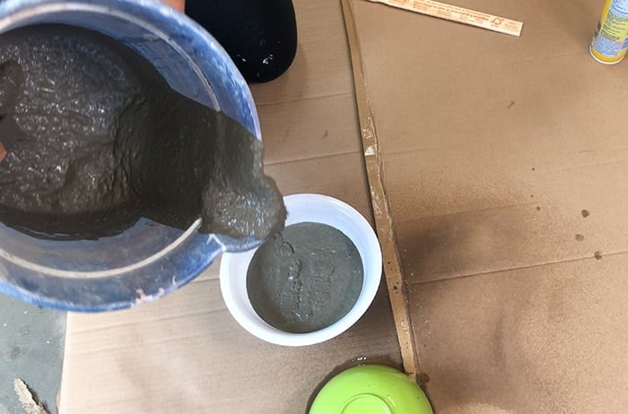 pouring concrete in bowl to make a hanging concrete planter