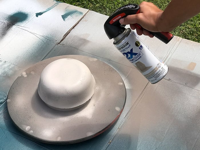 Painting the concrete planter with spray paint