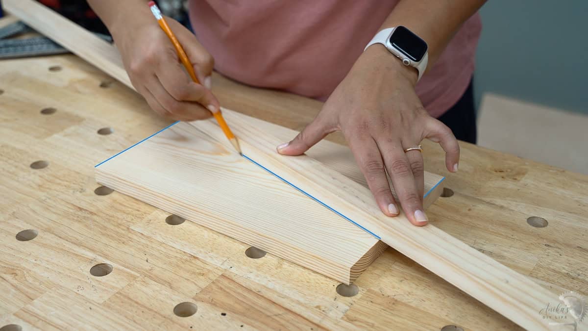 MArking the cut for the angled legs of the DIY footrest for under desk