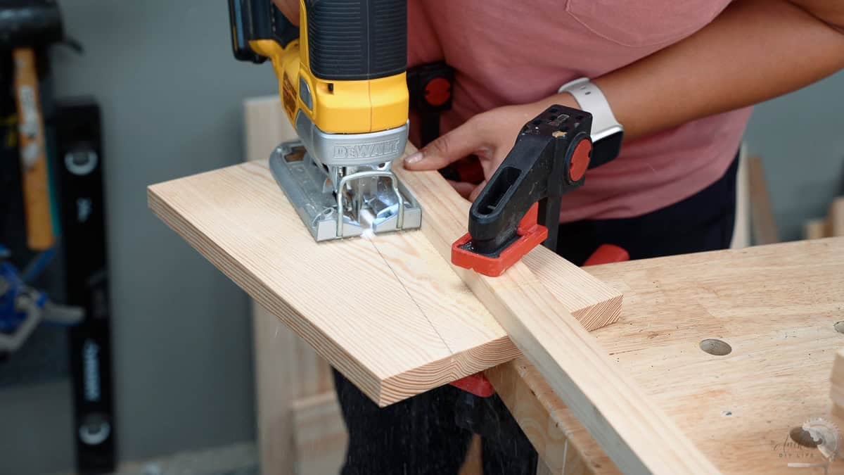 Cutting the angled cut for the legs of the DIY foot rest using jigsaw