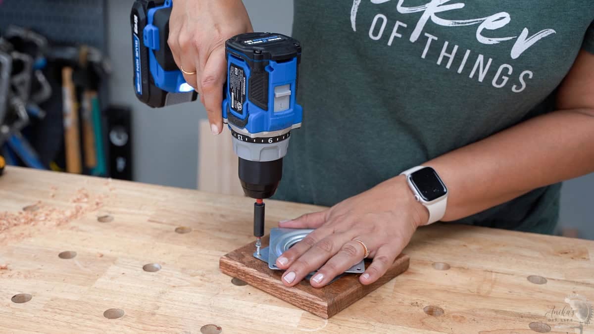 Woman attaching the lazy susan to the base for the rotating spice rack