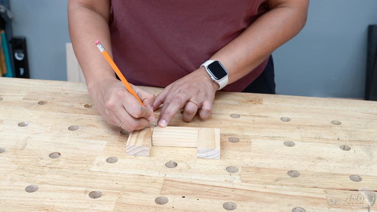 Marking location of the dowel holes on boards using a pencil