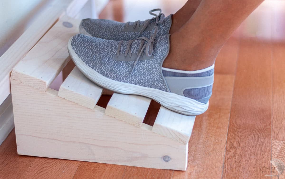 Woman sitting with feet on DIY foot rest