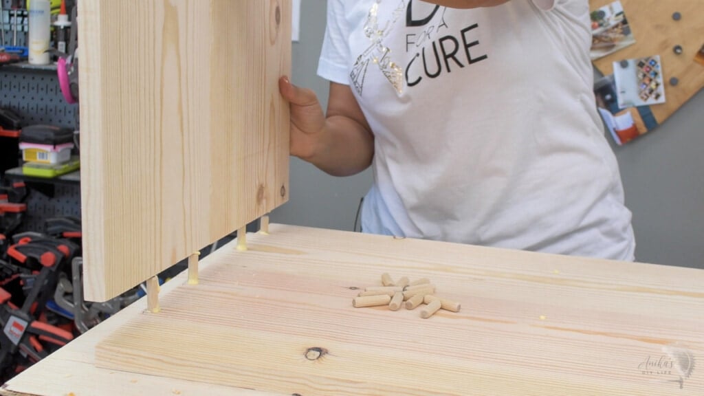 attaching the sides of the table. to the top using dowels and wood glue
