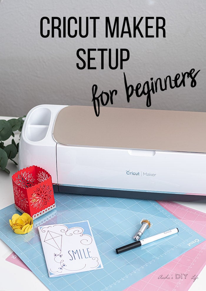 Cricut maker and a few paper crafts on table