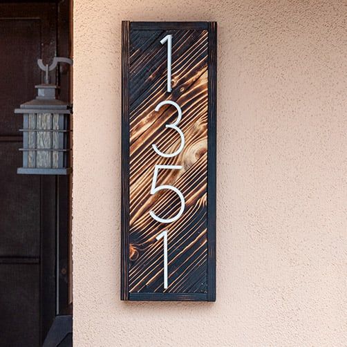 DIY house number sign with gradient wood burning on the wall