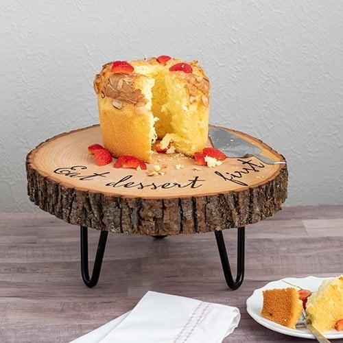 Learn how to make an easy customized DIY wood slice cake stand. The hairpin legs add rustic farmhouse charm to the gorgeous wooden cake stand. Perfect for any occasion.