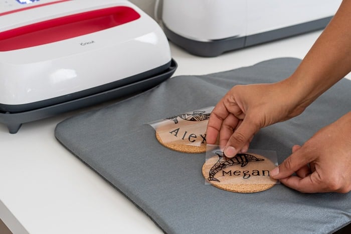 Placing the iron on vinyl on cork coasters
