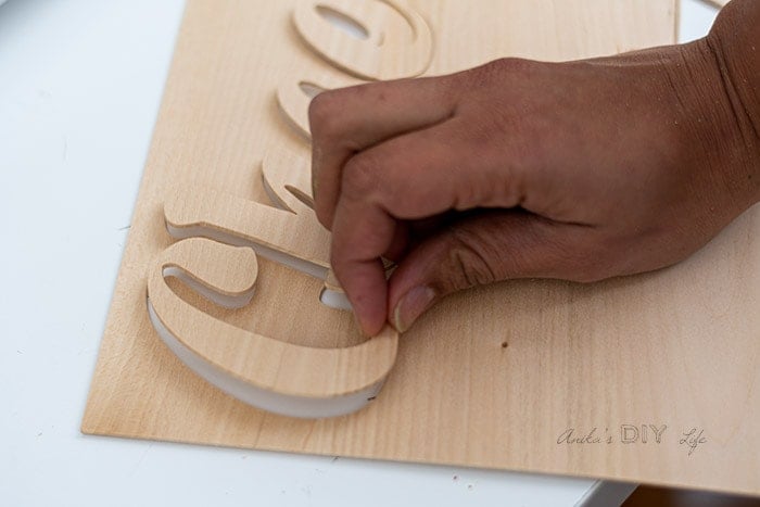 removing cut wooden letters from mat