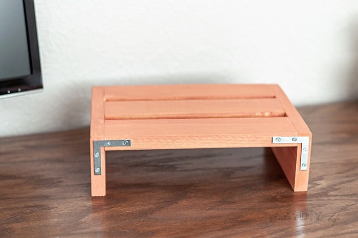 Painted laptop desk stand with metal corner braces for an industrial accent