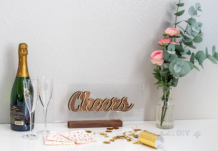 Full view of the Cheers sign with champaign and flowers