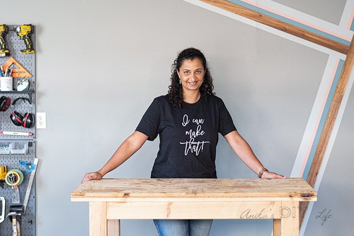woman standing in workshop with painted accent wall