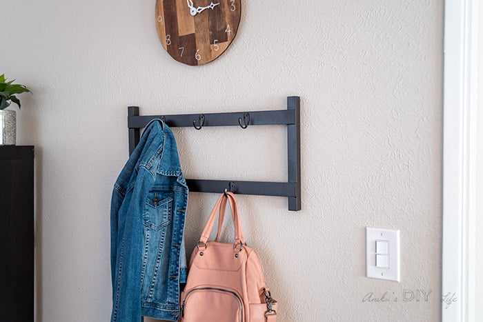 DIY metal coat rack with jacket and bag hanging