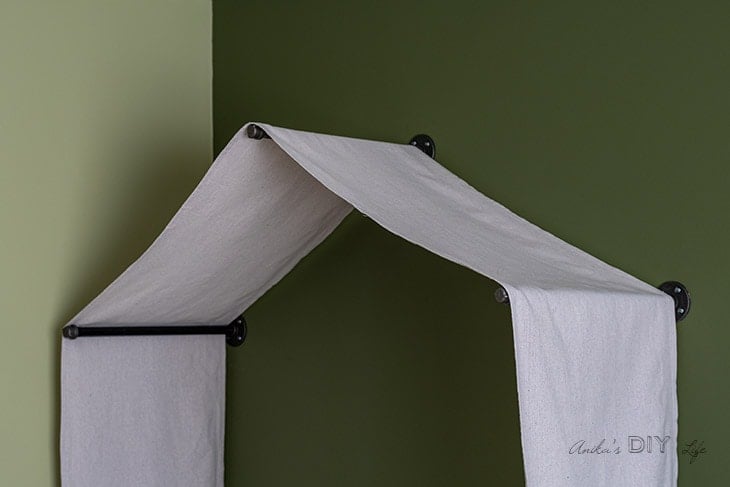 A DIY canopy tent using drop cloth and industrial pipes