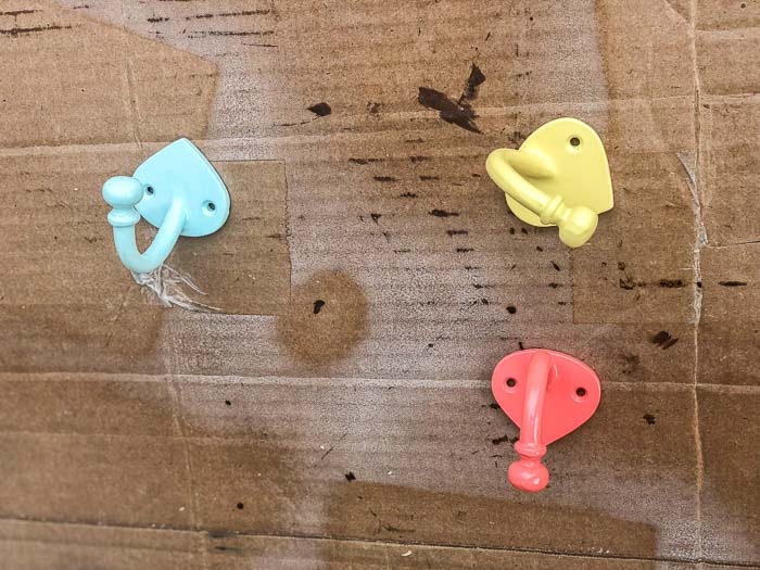 Spray painted hooks in blue, yellow and coral