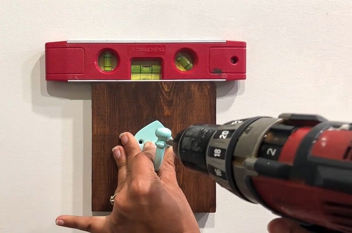installing hooks into the wood board and into the dry wall