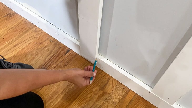 marking excess board to be cut off for a perfect fit