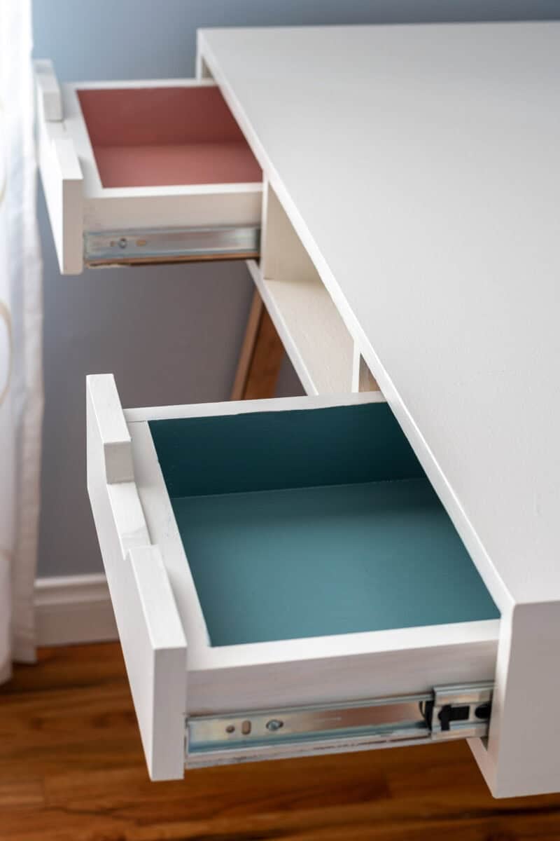 Insides of the Desk drawers. They are painted pink and teal.