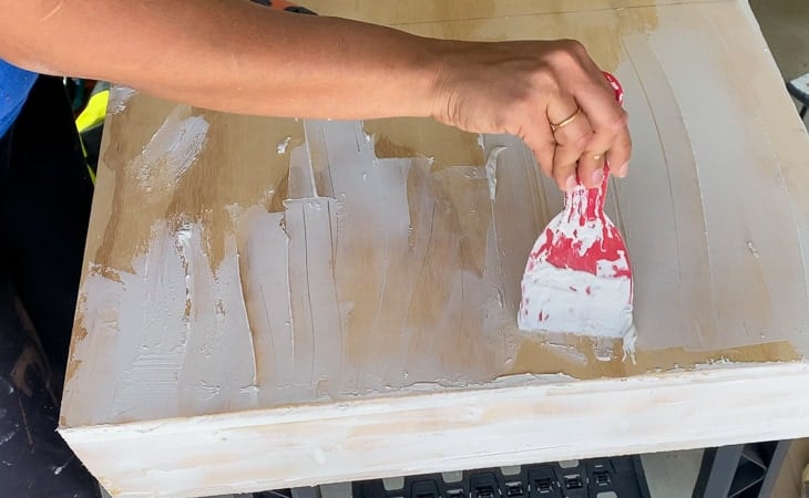 applying joint compound on the DIY desk