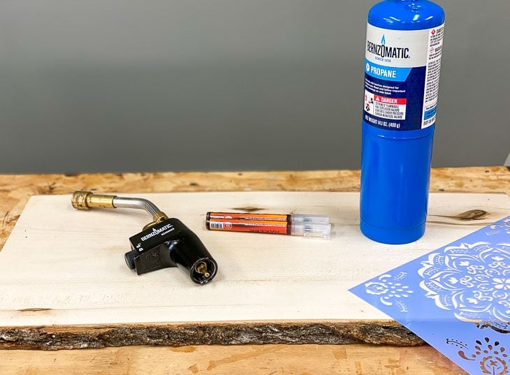 Materials needed to make the wood burned mandala tray on a workbench