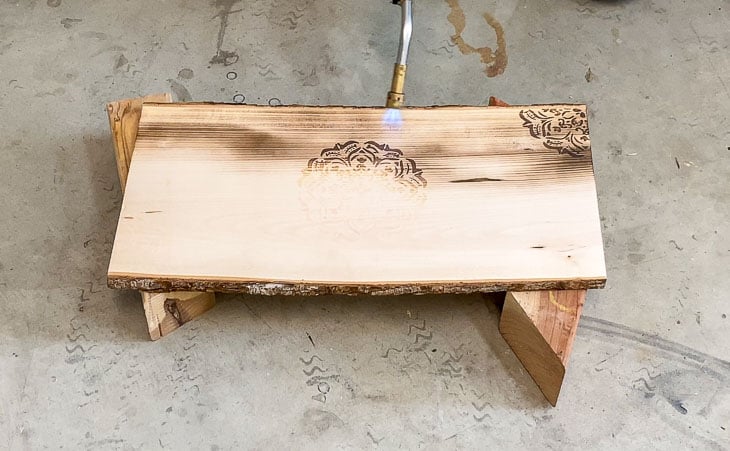 burning wood plank with propane blow torch