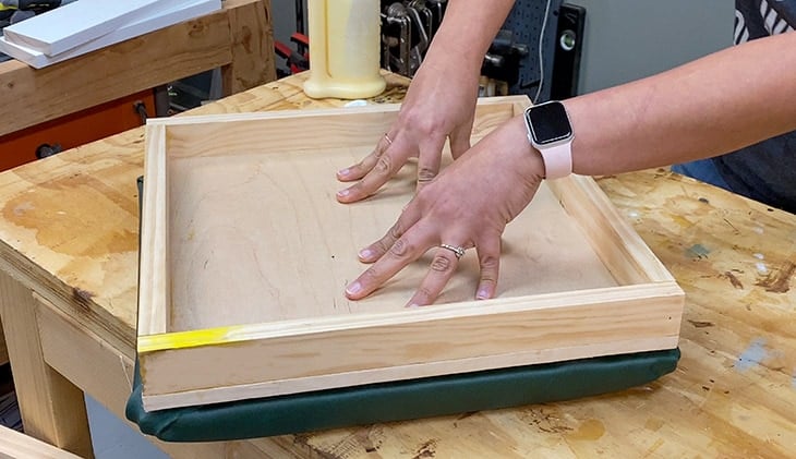 Attaching tray to the upholstered top of the ottoman