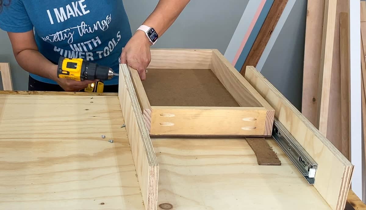 Anika attaching the drawers to the boxes for the diy desk