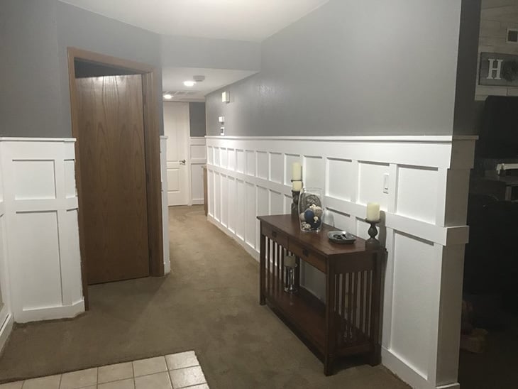 Hallway lined with white board and batten