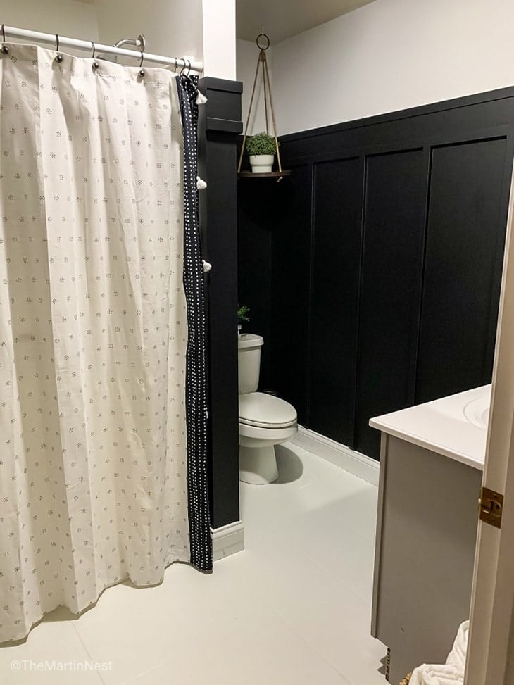 Black three-quarter board and batten wall in white bathroom!