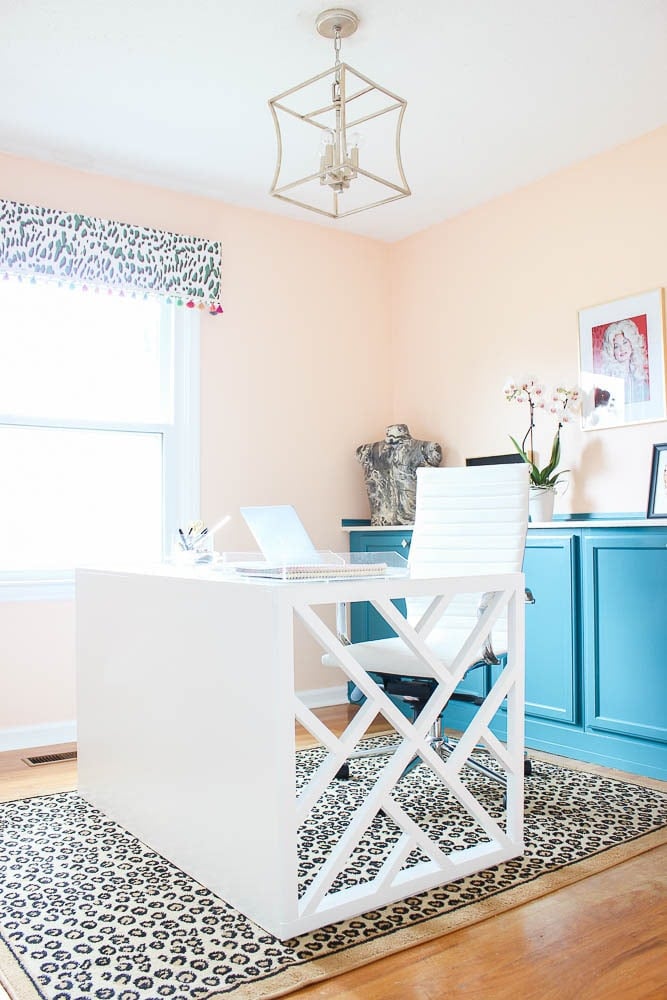 White chippendale inspired desk on a leopard print rug
